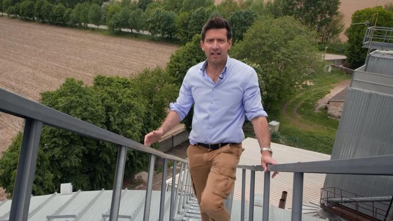 Dominic Waghorn climbs up a grain cellar in Ukraine