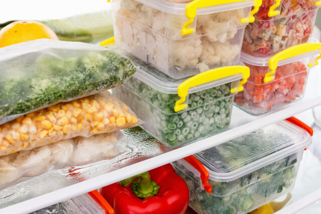 Frozen food in the refrigerator. Vegetables on the freezer shelf.