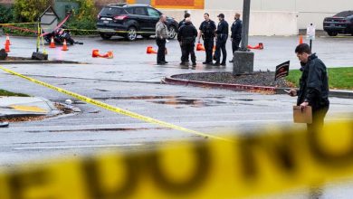 Authorities collect evidence in a parking lot near a shopping mall after a shooting Monday in Boise, Idaho.