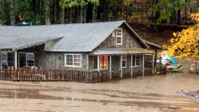 Floodwaters from Lake Madrone flow past a house on Oro Quincy Highway on Sunday, Oct. 24, 2021, in Butte County, Calif.