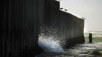 Ocean water sprays through the border fence as the tide rolls in at Border Field State Park on February 13, 2017 in San Diego, CA.