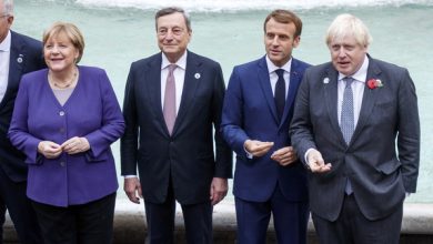 From left, German Chancellor Angela Merkel, Italian Premier Mario Draghi, French President Emmanuel Macron and British Prime Minister Boris Johnson stand at the Trevi Fountain during an event for the G20 summit in Rome, Sunday, Oct. 31, 2021.