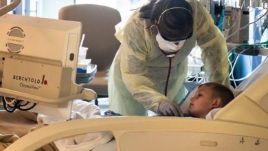 Kristen Brown, a nurse practitioner in the PICU at the University of Iowa Stead Family Children's Hospital, cares for 6-year-old Jaxon Philip, a pediatric COVID-19 patient on Oct. 6, 2021.