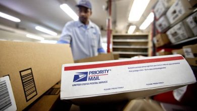 In this Feb. 7, 2013, file photo, packages wait to be sorted in a Post Office as U.S. Postal Service letter carrier Michael McDonald, gathers mail to load into his truck before making his delivery run, in Atlanta.