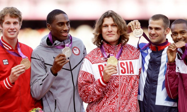 Medalists in the men's high jump, from left, Canada's Derek Drouin, bronze, United States' Erik Kynard, silver, Russia's Ivan Ukhov, gold, Britain's Robert Grabarz , bronze, and Qatar's Mutaz Essa Barshim, bronze, pose for the media during the athletics in the Olympic Stadium at the 2012 Summer Olympics, London, Wednesday, Aug. 8, 2012. (AP Photo/Ben Curtis, File)