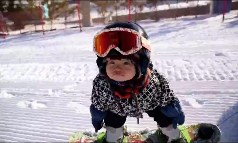 Watch this 11-month-old still not master snowboarding down the mountain