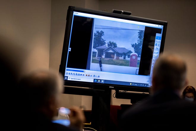 Prosecutor Linda Dunikoski shows a picture of the construction site where Ahmaud Arbery entered the structure during the trial of Greg McMichael and his son, Travis McMichael, and a neighbor, William "Roddie" Bryan in the Glynn County Courthouse, Tuesday, Nov. 9, 2021, in Brunswick, Ga.