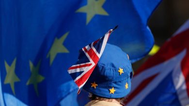 In this Oct. 16, 2018, file photo, a pro-EU demonstrator wears an EU flag styled as a hat, with a British Union flag pinned to it in London. (AP Photo/Alastair Grant, File)