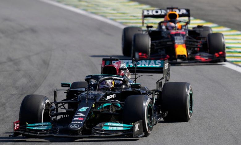 Mercedes' Lewis Hamilton, front, steers his car followed by Red Bull's Max Verstappen , during the Brazilian Formula One Grand Prix at the Interlagos race track in Sao Paulo, Brazil, Sunday, Nov. 14, 2021. (AP Photo/Andre Penner)