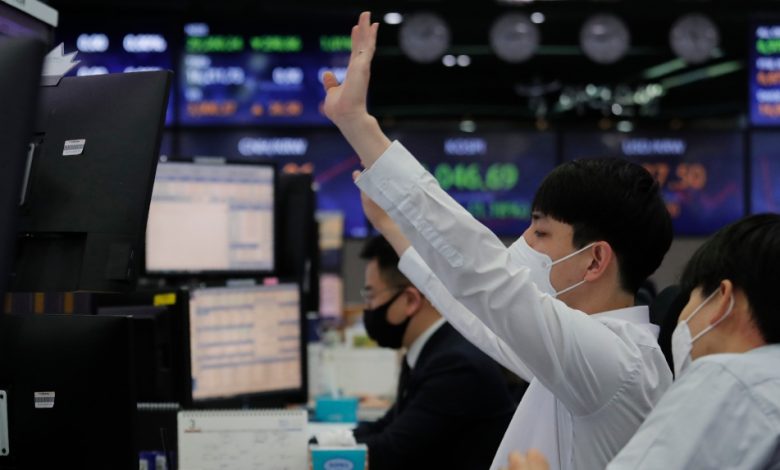 Asian shares mostly lower despite Dow's push over 36,000