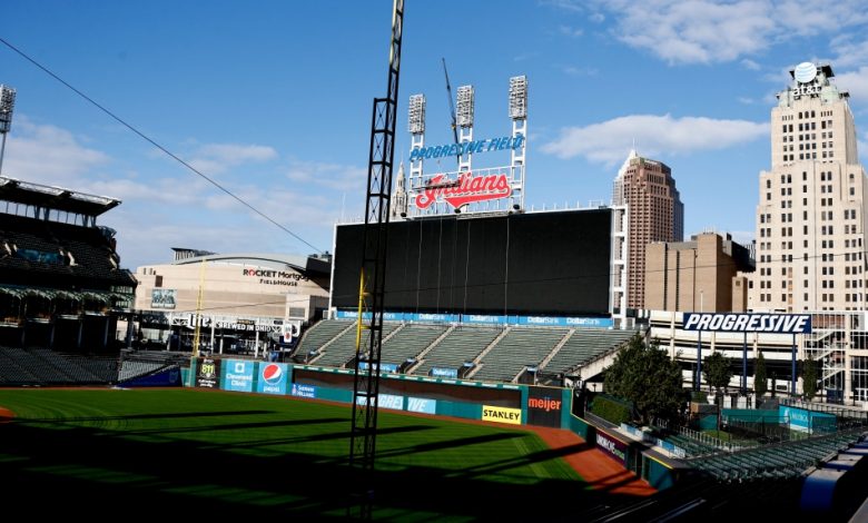 Workers begin to remove the Cleveland Indians sign from above the scoreboard at Progressive Field, Tuesday, Nov. 2, 2021, in Cleveland. Known as the Indians since 1915, Cleveland's Major League Baseball team will be called Guardians. (AP Photo/Ron Schwane)