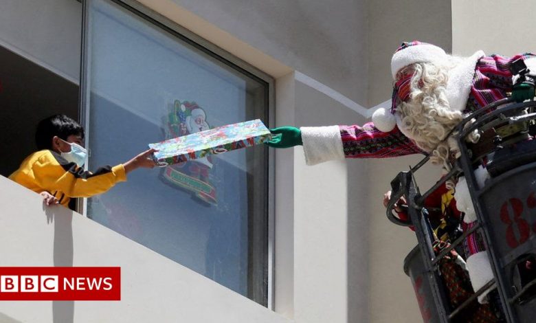Santa Claus delivers presents to children in Peru ... through a fire ladder