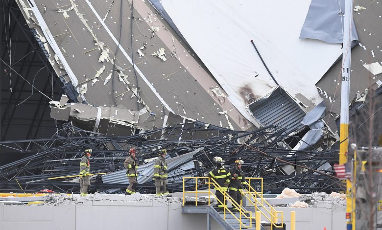 First responders survey a damaged Amazon Distribution Center on December 11, in Edwardsville, Illinois. (Michael B. Thomas/Getty Images)