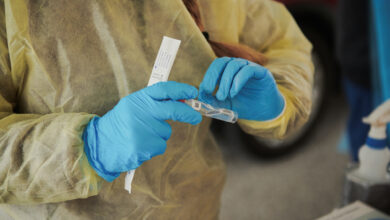 A healthcare worker labels a test tube containing a Covid-19 test in Omaha, Nebraska, on November 10.