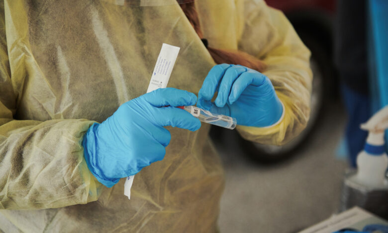 A healthcare worker labels a test tube containing a Covid-19 test in Omaha, Nebraska, on November 10.