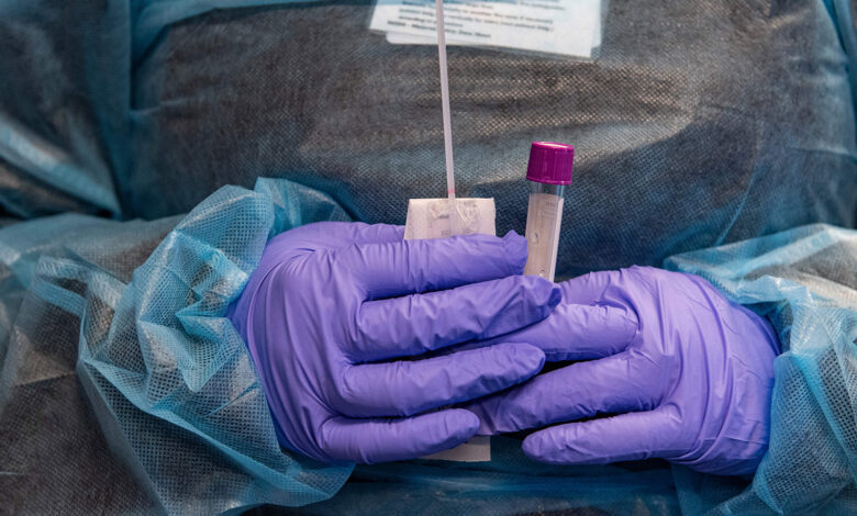 A medical worker prepares a Covid-19 PCR test at East Boston Neighborhood Health Center in Boston, Massachusetts on December 20.