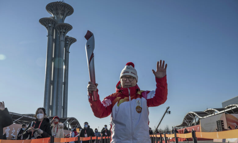 Olympic torch begins its Covid-shortening trip through Beijing landmarks