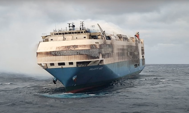 The scorched cargo ship carrying thousands of vehicles was finally towed