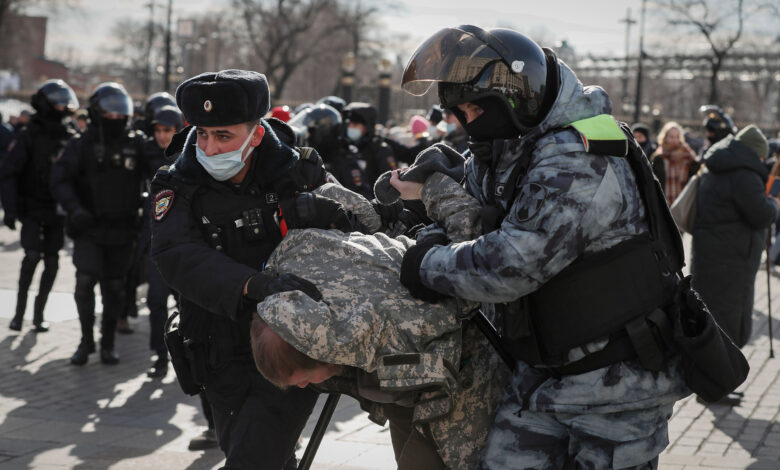 Russian police detain a protester in downtown Moscow on March 6.