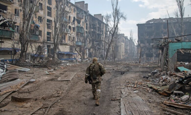 A Russian soldier walks amidst the rubble in Mariupol's eastern side on April 15.