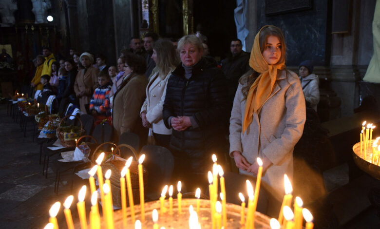 Worshippers attend a service marking Orthodox Easter at Saints Peter and Paul Garrison Church, in Lviv, on Saturday, April 23. Ukrainian authorities urged those celebrating Orthodox Easter to follow religious services online and to respect curfews amid fighting with Russian troops despite a holiday that usually attracts crowds.