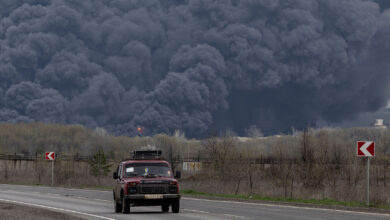 A car passes an oil refinery in Lysychansk after if was hit by a missile in the Luhansk region in Ukraine on Saturday.