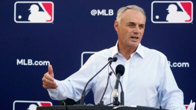 Commissioner Rob Manfred gives headphones to major league players as a peace offer during lockdown