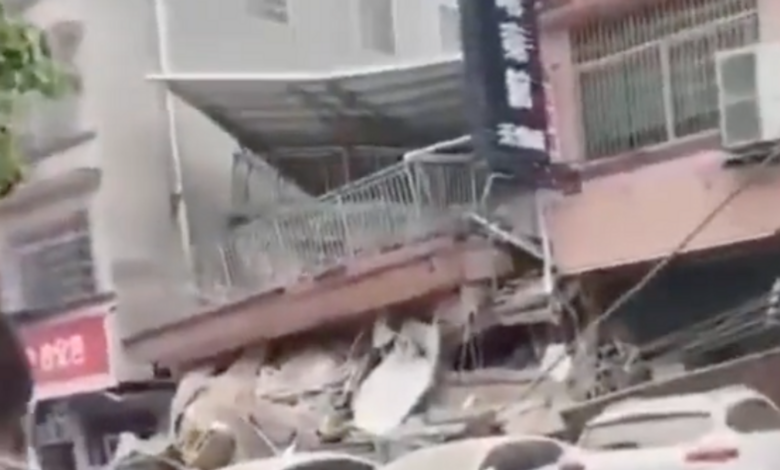 Footage on social media showed people stood watching in shock as the building collapsed. Pic: Twitter @LovingChinaMI.