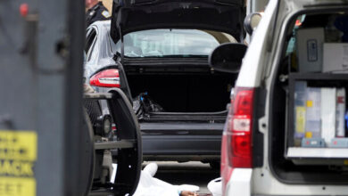 A body lies in the parking lot of a supermarket in Buffalo, where 10 people were killed in a shooting on Saturday.