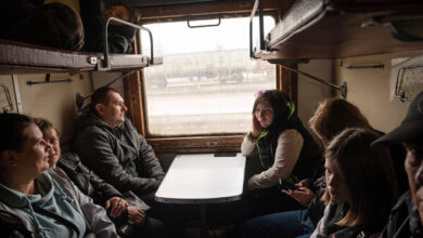 Ukrainian families, who have fled their homes, on a train heading out of Pokrovsk, northwest of Donetsk, Ukraine, on Tuesday.