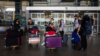 Passengers wearing face masks arrive at Adolfo Suarez-Barajas international airport, outskirts Madrid, Spain, Sunday, June 21, 2020. Spain opened its borders to European tourists on Sunday in a bid to kickstart its vital tourism economy, but Brazil and South Africa reported record new levels of coronavirus infections. (AP Photo/Bernat Armangue)