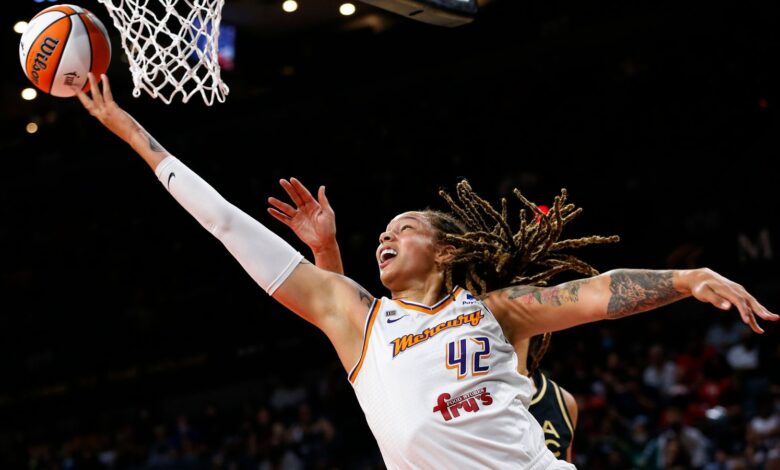 Phoenix Mercury center Brittney Griner (42) shoots around Las Vegas Aces center Liz Cambage during the first half of Game 5 of a WNBA basketball playoff series Friday, Oct. 8, 2021, in Las Vegas. (AP Photo/Chase Stevens)