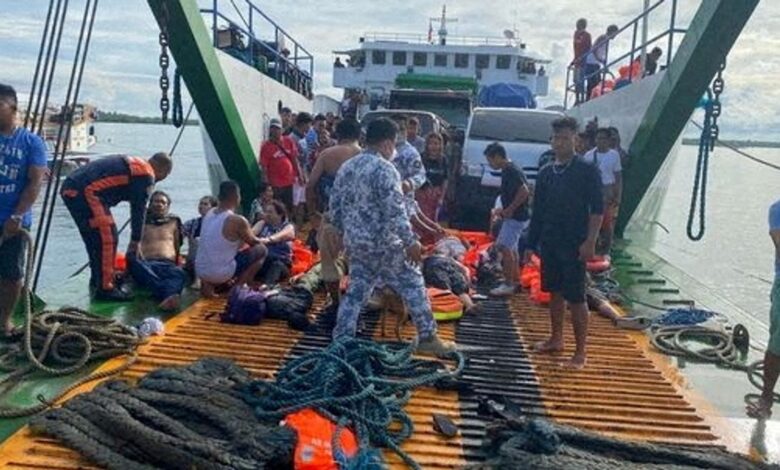 Philippine Coast Guard personnel assist rescued passengers after a vessel carrying more than 100 people caught fire near Real, Quezon province