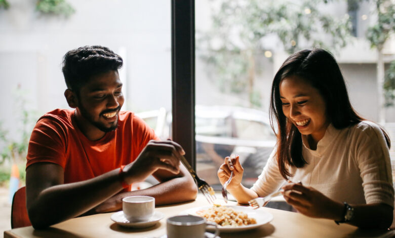 Man and women sharing food on a dinner date