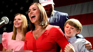 Katie Britt stand with her family during her victory party Tuesday evening in Montgomery, Alabama.