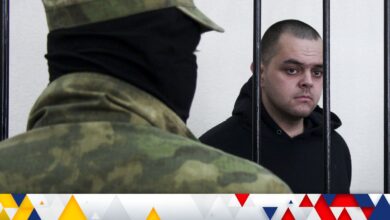 Briton Aiden Aslin stands behind bars in a courtroom in Donetsk, in the territory which is under the Government of the Donetsk People's Republic control, eastern Ukraine, Thursday, June 9, 2022. Aslin is one of two British citizens and a Moroccan national who have been sentenced to death by pro-Moscow rebels in eastern Ukraine for fighting on Ukraine's side. The three men fought alongside Ukrainian troops and surrendered to Russian forces weeks ago.