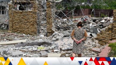 An elderly woman walks next to a building damaged by an overnight missile strike in Sloviansk, Ukraine, Wednesday, June 1, 2022. (AP Photo/Andriy Andriyenko)