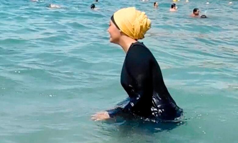 A woman wears a burkini in the water. Pic: AP