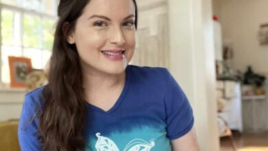 Girl posing in living room wearing a blue butterfly shirt