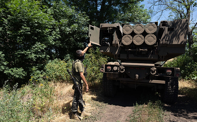 The commander of an Ukranian unit shows the rockets on HIMARS vehicle in Eastern Ukraine on July 1.