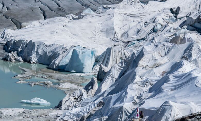 Parts of the Rhone Glacier are covered in blankets above Gletsch near the Furkapass in Switzerland, on Wedensday, 13 July 2022. The Alps oldest glacier is protected by special white blankets to prevent it from melting. (Urs Flueeler/Keystone via AP)