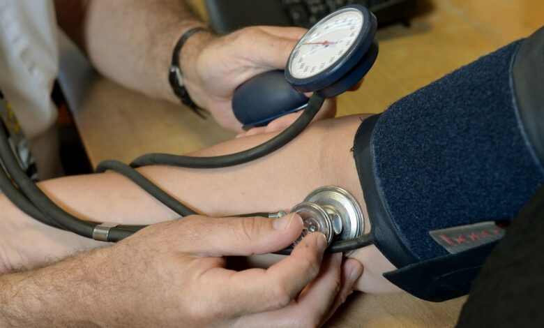 File photo dated 10/09/14 of a doctor checking a patient's blood pressure. High blood pressure could be treated with an injection every six months instead of a daily tablet as part of a new trial into the condition.