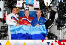 Russian cosmonauts Oleg Artemyev, Denis Matveev and Sergey Korsakov pose with a flag of the self-proclaimed Luhansk People's Republic at the International Space Station (ISS), in this picture released July 4, 2022. Roscosmos/Handout via REUTERS ATTENTION EDITORS - THIS IMAGE HAS BEEN SUPPLIED BY A THIRD PARTY. MANDATORY CREDIT.