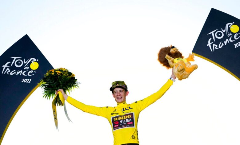 Tour de France winner Denmark's Jonas Vingegaard, wearing the overall leader's yellow jersey, celebrates on the podium after the twenty-first stage of the Tour de France cycling race over 116 kilometers (72 miles) with start in Paris la Defense Arena and finish on the Champs Elysees in Paris, France, Sunday, July 24, 2022. (AP Photo/Thibault Camus)