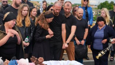 Relatives and friends react near the coffin during a funeral ceremony for Liza, 4-year-old girl killed by Russian attack, in Vinnytsia, Ukraine, Sunday, July 17, 2022. Wearing a blue denim jacket with flowers, Liza was among 23 people killed, including 2 boys aged 7 and 8, in Thursday's missile strike in Vinnytsia. Her mother, Iryna Dmytrieva, was among the scores injured. (AP Photo/Efrem Lukatsky)