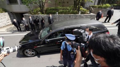 A car carrying the body of Shinzo Abe arrives at his home. Pic: AP