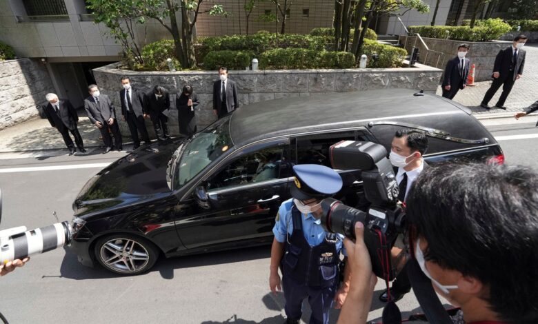 A car carrying the body of Shinzo Abe arrives at his home. Pic: AP