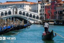 Surfers on Venice's Grand Canal spark the mayor's fury