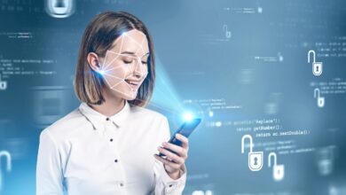 Smiling young woman in formal clothes using smartphone with face recognition technology over blurry blue background. Concept of biometric authentication and cyber security. Toned image double exposure