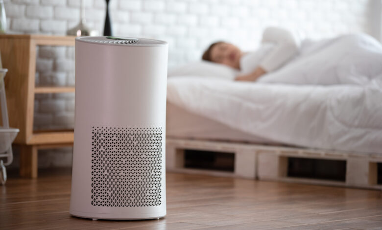 woman sleep with air purifier in cozy white bed